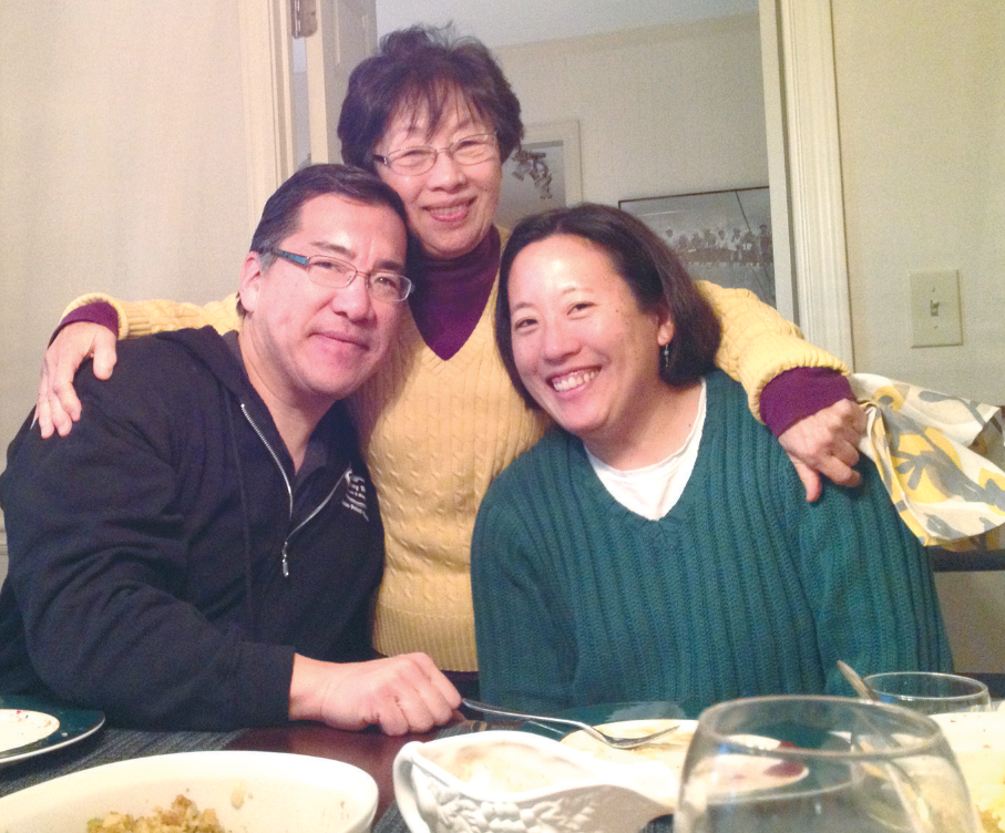mother father and Young Kim at the kitchen table