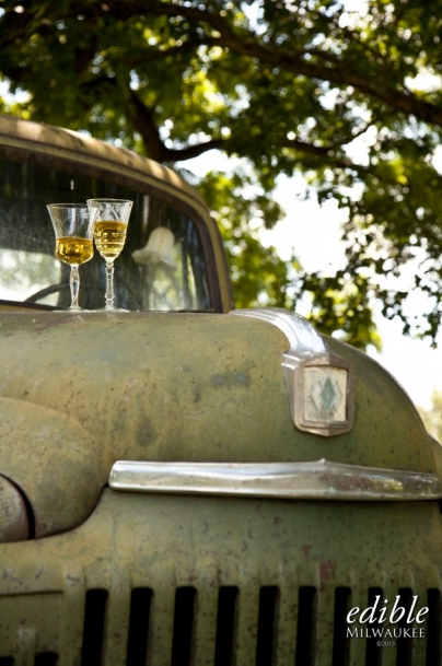 two glasses of cider on an old car